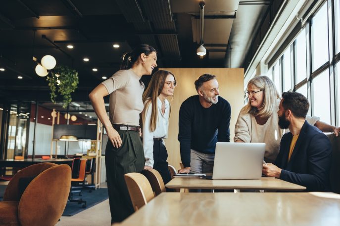 Business team collaborating and smiling during a presentation meeting