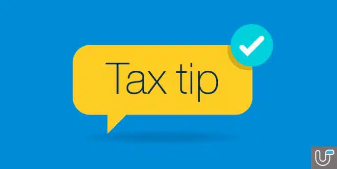 Tax tip icon in a yellow speech bubble with a check mark on a blue background