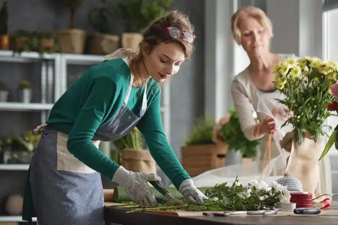 Two women arranging flowers in a florist shop