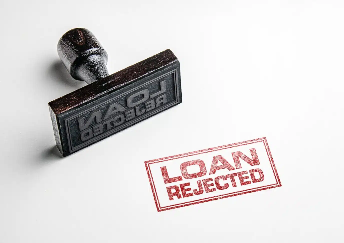 Rubber stamp imprint reading "Loan Rejected" on white paper