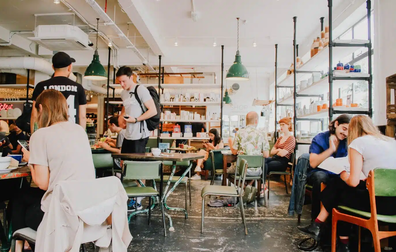 People working and socializing inside a vibrant modern café.