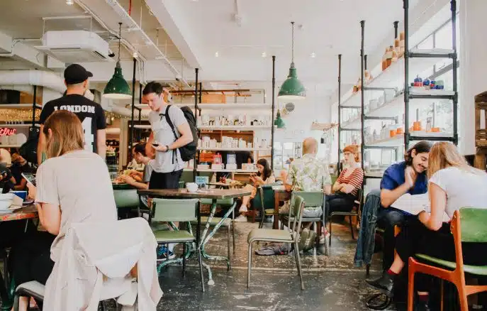 People working and socializing inside a vibrant modern café.