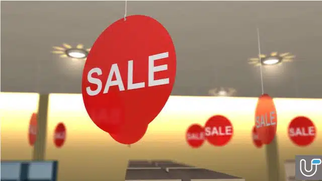 Red sale signs hanging from the ceiling in a retail store during a promotional event