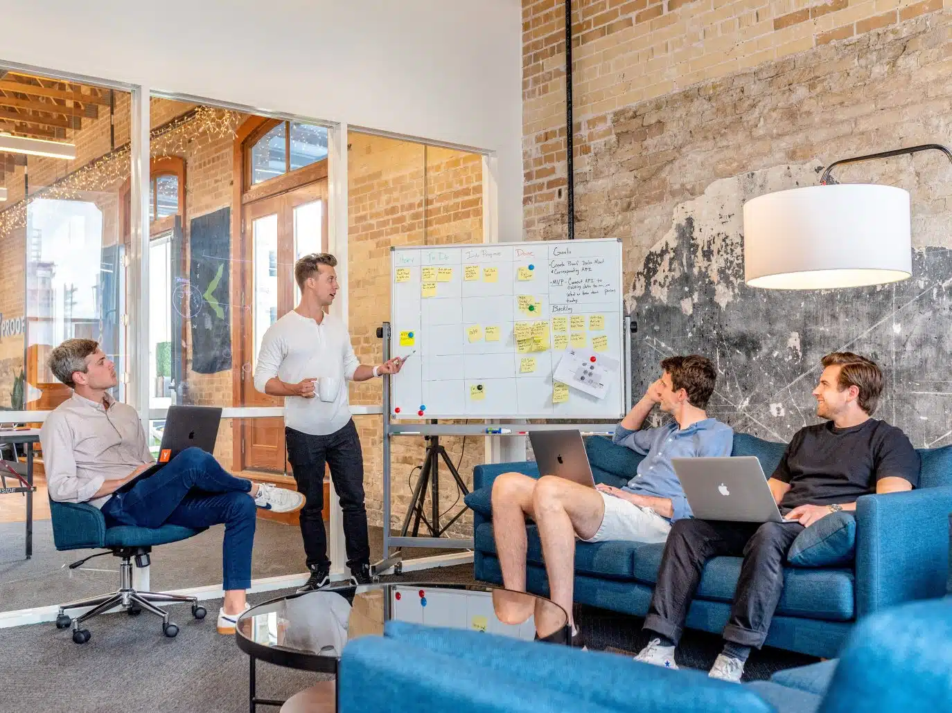 Team collaborating around a whiteboard in a modern office setting.