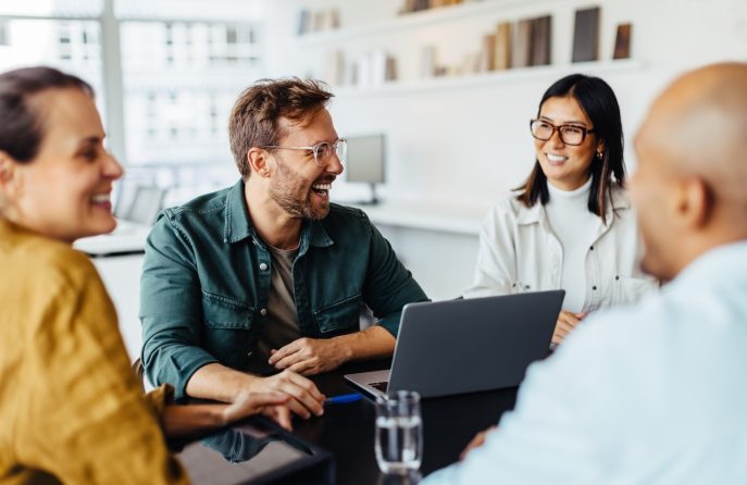 Smiling team of small business professionals having a collaborative strategy meeting in a bright modern office